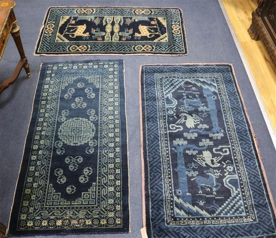 Three Chinese blue ground mats, 120 x 65cm, 120 x 57cm & 110 x 60cm